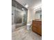 Modern bathroom boasts tiled walk-in shower, granite countertop, and integrated sink at 9840 Queensway Blvd. # 329, Myrtle Beach, SC 29572