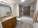 Bright bathroom features granite countertop, integrated sink, and tiled tub-shower at 9840 Queensway Blvd. # 329, Myrtle Beach, SC 29572