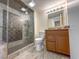 Modern bathroom boasts tiled walk-in shower, granite countertop, and integrated sink at 9840 Queensway Blvd. # 329, Myrtle Beach, SC 29572