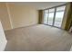 Bright and spacious bedroom with neutral carpeting and sliding glass doors to a balcony at 9840 Queensway Blvd. # 329, Myrtle Beach, SC 29572