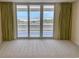 Serene bedroom showcasing large windows with stunning ocean views and soft carpeting at 9840 Queensway Blvd. # 329, Myrtle Beach, SC 29572