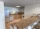 Kitchen with white appliances and an expansive counterspace with a breakfast bar at 9840 Queensway Blvd. # 329, Myrtle Beach, SC 29572