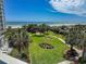 Beautiful view from the balcony, overlooking manicured lawns, tall trees and a sandy beach at 9840 Queensway Blvd. # 329, Myrtle Beach, SC 29572