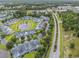 Aerial view of community, pond with fountain, green spaces, and nearby roadways and shopping at 1053 Williston Loop # 1053, Murrells Inlet, SC 29576