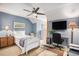Bright bedroom featuring a white bed, a ceiling fan, and a dedicated workspace for studying and relaxation at 1053 Williston Loop # 1053, Murrells Inlet, SC 29576