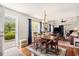 Cozy dining area featuring a wooden table, chairs, and natural light from the glass door at 1053 Williston Loop # 1053, Murrells Inlet, SC 29576