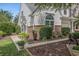 Well-maintained townhome with white siding, brick accents, and a landscaped walkway at 1053 Williston Loop # 1053, Murrells Inlet, SC 29576