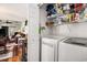 Convenient laundry area with washer, dryer, and shelving for storage, adjacent to the living area at 1053 Williston Loop # 1053, Murrells Inlet, SC 29576