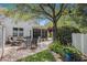 Charming patio with outdoor seating beneath a large tree, surrounded by lush landscaping at 1053 Williston Loop # 1053, Murrells Inlet, SC 29576