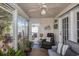 Inviting sunroom with view of outdoor patio, featuring a leather recliner and comfortable seating at 1053 Williston Loop # 1053, Murrells Inlet, SC 29576