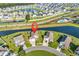 Aerial view of a neighborhood with waterfront homes, well-manicured lawns, and convenient street access at 1124 Valetto Loop, Myrtle Beach, SC 29579