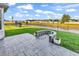 Paver patio in a grassy backyard overlooking a tranquil pond with neighborhood view at 1124 Valetto Loop, Myrtle Beach, SC 29579