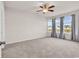 Light-filled bedroom features carpet, ceiling fan, and view of the backyard at 1124 Valetto Loop, Myrtle Beach, SC 29579