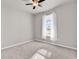 Bright bedroom with ceiling fan and window dressed with sheer white curtains at 1124 Valetto Loop, Myrtle Beach, SC 29579