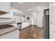 Modern kitchen features white cabinets, granite countertops, stainless steel appliances and wood flooring at 1124 Valetto Loop, Myrtle Beach, SC 29579