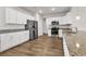 Modern kitchen features white cabinets, granite countertops, stainless steel appliances and wood flooring at 1124 Valetto Loop, Myrtle Beach, SC 29579