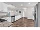 Modern kitchen features white cabinets, granite countertops, stainless steel appliances and wood flooring at 1124 Valetto Loop, Myrtle Beach, SC 29579