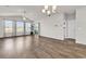 Bright living room with wood floors, ceiling fan and natural lighting through large windows at 1124 Valetto Loop, Myrtle Beach, SC 29579