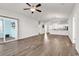 Spacious living room features wood floors, sliding glass doors and open kitchen view at 1124 Valetto Loop, Myrtle Beach, SC 29579