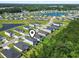 Aerial view shows houses in the neighborhood, with lawns, and streets at 1146 Joywood Dr., Longs, SC 29568