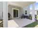 Covered back porch features grill, rocking chairs, sliding door, and outdoor lighting at 1146 Joywood Dr., Longs, SC 29568