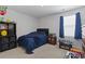 Cozy bedroom with neutral carpet and dark blue bedding with ample decorations at 1146 Joywood Dr., Longs, SC 29568