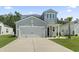 Charming two-story home featuring a two-car garage, a well-manicured lawn, and curb appeal at 1146 Joywood Dr., Longs, SC 29568