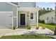 Charming home featuring a covered front porch, dark door, and white rock landscaping at 1146 Joywood Dr., Longs, SC 29568