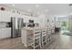 Modern kitchen with stainless steel appliances, granite countertops, and a large island with seating, with an open view to the living room at 1146 Joywood Dr., Longs, SC 29568