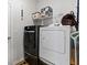 Functional laundry room with washer, dryer, and shelving for storage solutions at 1146 Joywood Dr., Longs, SC 29568