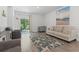 Bright living room with a starfish-patterned rug, modern decor, and a sliding glass door at 1146 Joywood Dr., Longs, SC 29568