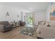 Comfortable living room with plush seating, area rug, and access to the backyard at 1146 Joywood Dr., Longs, SC 29568