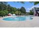 Large community pool with ample seating and a fountain, surrounded by lush landscaping at 1196 Harvester Circle # 1196, Myrtle Beach, SC 29579