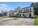 Exterior view of townhome with well-manicured lawn, neutral siding, and a concrete driveway at 1196 Harvester Circle # 1196, Myrtle Beach, SC 29579