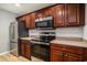 Close up of kitchen featuring stainless steel appliances, dark wood cabinets, and wood floors at 1196 Harvester Circle # 1196, Myrtle Beach, SC 29579