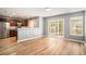 Open concept living area with modern wood floors and access to the kitchen and outdoor space at 1196 Harvester Circle # 1196, Myrtle Beach, SC 29579