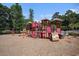 Community playground with multiple play stations and a nearby pool at 1196 Harvester Circle # 1196, Myrtle Beach, SC 29579