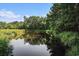 Scenic pond with trees and a water tower reflecting in its calm waters, creating a serene community landscape at 1196 Harvester Circle # 1196, Myrtle Beach, SC 29579