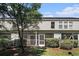 Back exterior view featuring the screened-in patio and meticulously cared-for landscaping at 1196 Harvester Circle # 1196, Myrtle Beach, SC 29579