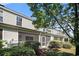 Rear exterior of the home showcasing a screened-in porch and well-maintained landscaping at 1196 Harvester Circle # 1196, Myrtle Beach, SC 29579