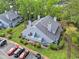 Aerial view of a well-maintained condo with balcony, surrounded by lush greenery, parking, and landscaping at 1206 Erin Way # A, Myrtle Beach, SC 29577