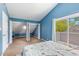 Bedroom features blue walls, carpet, a sliding door to the balcony, and closet space at 1206 Erin Way # A, Myrtle Beach, SC 29577