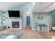 Open-concept living room with fireplace, a dining area, and a staircase to the upper floor at 1206 Erin Way # A, Myrtle Beach, SC 29577