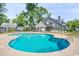 Community swimming pool with lounge chairs, surrounded by lush greenery and fencing for relaxation at 1206 Erin Way # A, Myrtle Beach, SC 29577