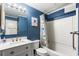 Modern bathroom with blue walls, stylish vanity, and a shower-tub combination with a themed curtain at 1310 N Waccamaw Dr. # 204, Garden City Beach, SC 29576