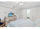 Inviting bedroom with nautical-themed decor, complemented by a ceiling fan, and access to the bathroom at 1310 N Waccamaw Dr. # 204, Garden City Beach, SC 29576