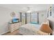 Bright bedroom featuring a dresser with a TV, and access to a private balcony with seating at 1310 N Waccamaw Dr. # 204, Garden City Beach, SC 29576
