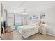 Cozy bedroom with beach-themed decor, light walls, a ceiling fan, and stylish beachy side tables at 1310 N Waccamaw Dr. # 204, Garden City Beach, SC 29576