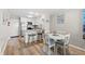 Compact kitchen with dining area, featuring stainless steel appliances and light wood flooring at 1310 N Waccamaw Dr. # 204, Garden City Beach, SC 29576