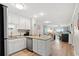 Open-concept kitchen with white cabinetry, granite counters, and views into the living area at 1310 N Waccamaw Dr. # 204, Garden City Beach, SC 29576